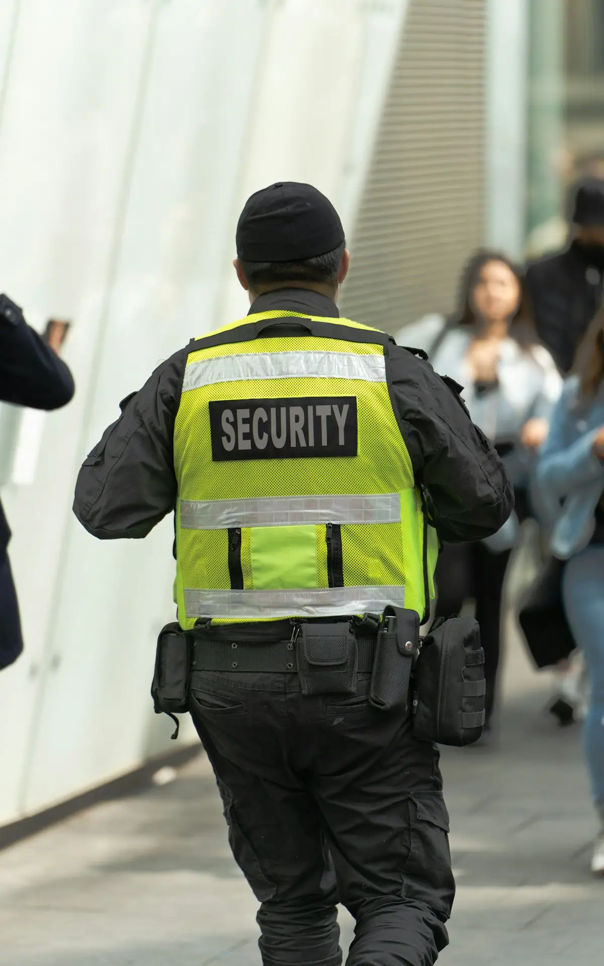 Uniformed security officer on patrol in a busy street
